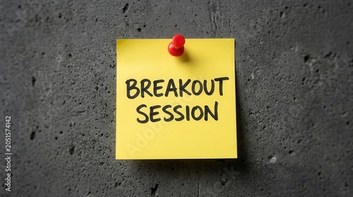 Yellow sticky note with breakout session handwriting for business training and teamwork group activity.
