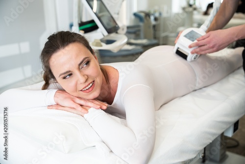 Woman enjoying a body treatment session in a modern wellness center