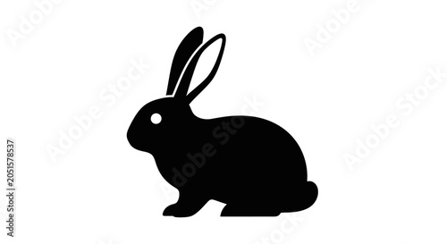 A simple black silhouette of a rabbit with a white eye, depicted in profile on a plain white background.