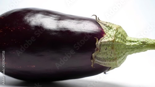 Close-up of a fresh purple eggplant on white background
