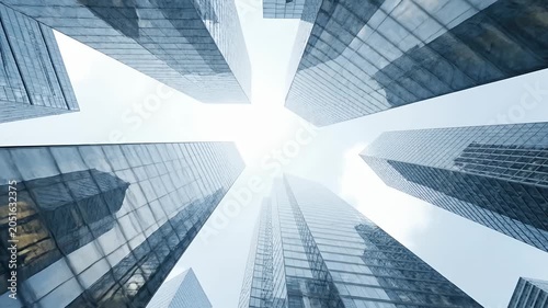 Low angle view of glass towers fading into light.