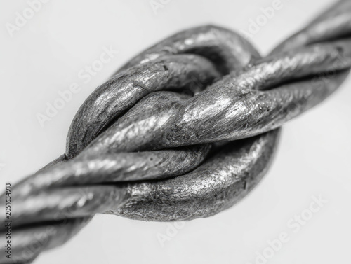Close-up of a metal knot on a twisted cable.