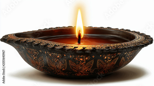 Traditional indian clay diya lamp with glowing flame isolated on white background