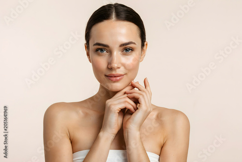 Beautiful model with glowing skin and elegant pose for luxury skincare campaign.