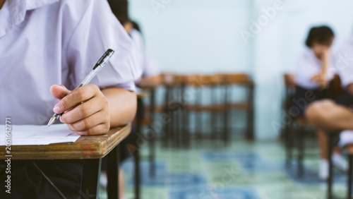 Close-up of Student Hand Writing on Exam Paper with Pen
