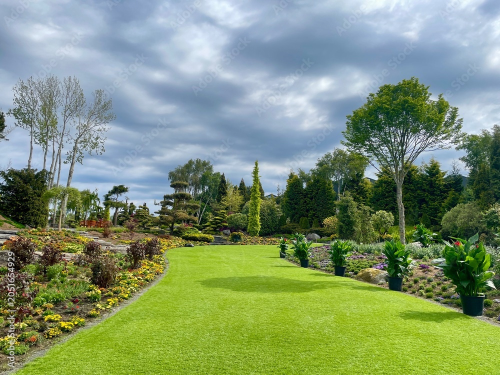 Fototapeta premium Beautiful resort park with fresh cut lawn and plants