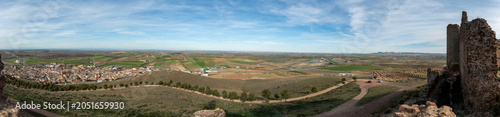 Panoramic view of a rural village with ancient ruins on a hill