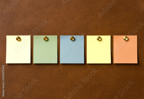Blank sticky notes pinned on corkboard minimalist flat lay neutral colors