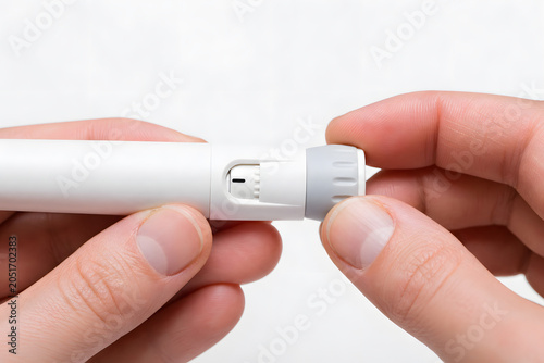 Hand adjusting dose on white injection pen