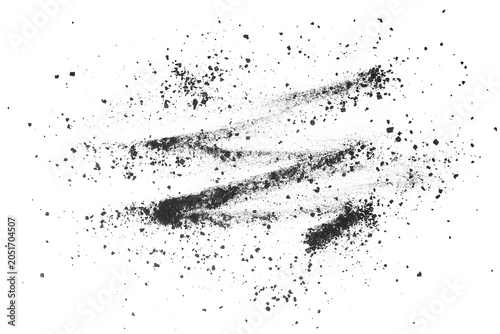 Foto Small black charcoal pieces and dust on a white background, top view