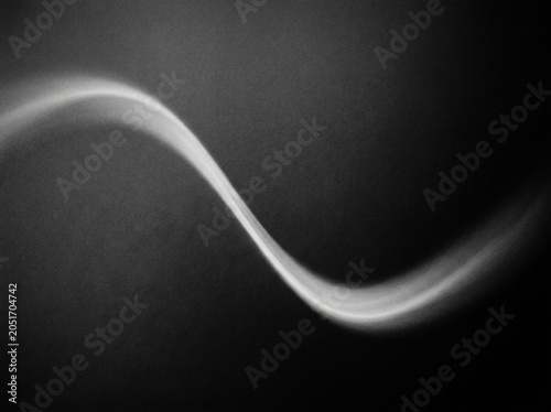 Monochrome gray grain abstract background wallpaper with subtle radial gradient illumination featuring soft texture pattern for creative digital design. 