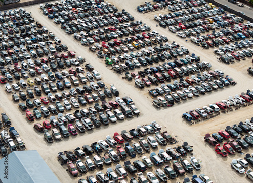 Drone view shows a vast scrap yard filled with cars