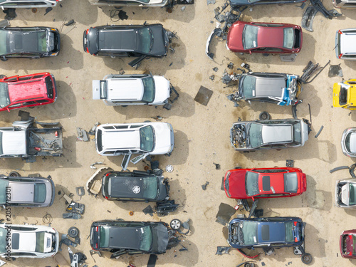 Overhead shot of a car junkyard with broken vehicles