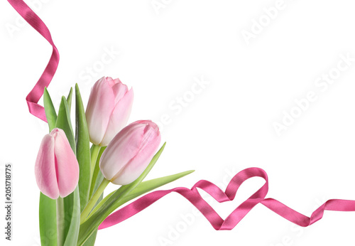 Beautiful tulips and heart made of pink ribbon on white background