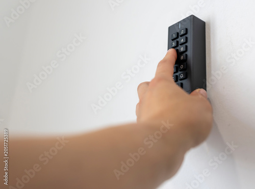 Schilderij op canvas Hand entering temporary access code into secure smart lock system designed for a