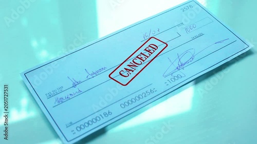 Cheque document canceled hand stamps seal on official paper insufficient funds in 4K Ultra HD footage.
