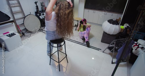 Photographer with Pink Hair and Model in Photo Studio: Photoshoot Session, Posing, and Professional Photography