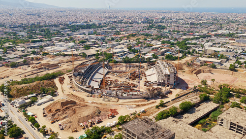 Canvas-taulu Large sports stadium building project underway with cranes and heavy machinery,