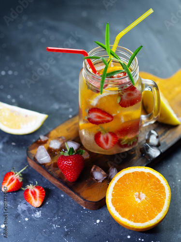 Summer detox drink with strawberries, orange and lemon. Cold homemade lemonade