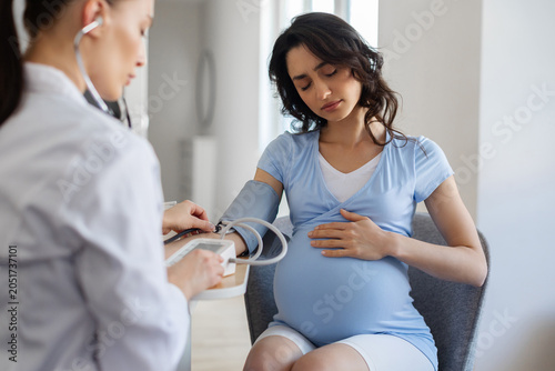 Canvastavla Pregnant woman feeling unwell during blood pressure examination at prenatal appo