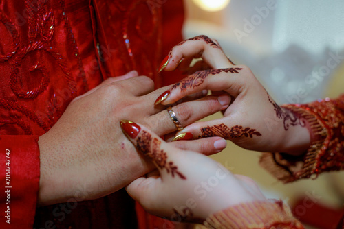 Slika na platnu A detailed close-up capturing the moment the bride places a silver or white gold