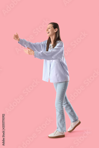 Happy young woman opening a...