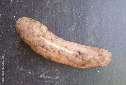 boiled sweet potato isolated on dark wooden background
