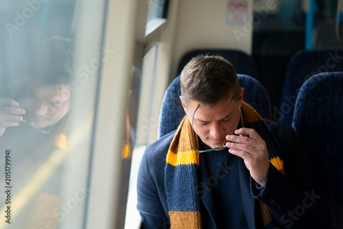 Passenger using smartphone during railway commute