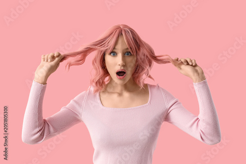 Shocked young woman in pink...