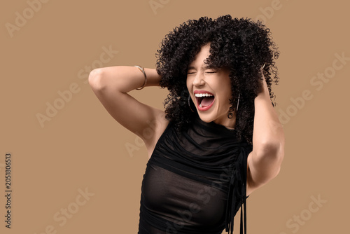 Happy young woman in curly ...