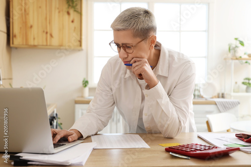 Mature woman in debt using ...