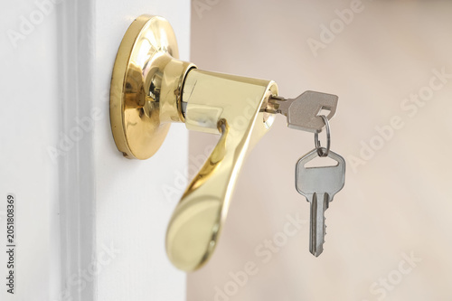 Open door with key in rente...