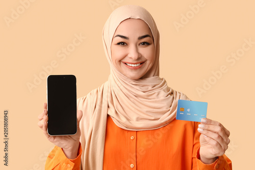 Muslim woman with credit ca...