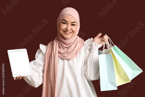 Muslim woman with shopping ...