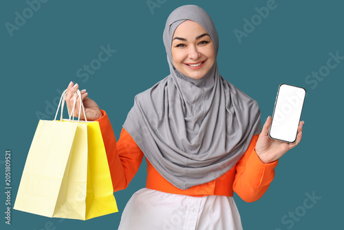 Muslim woman with shopping ...