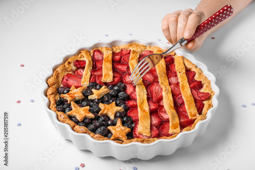 Woman with fork eating tast...