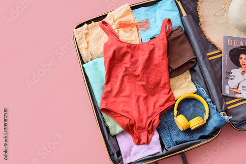 Open suitcase with beach ac...