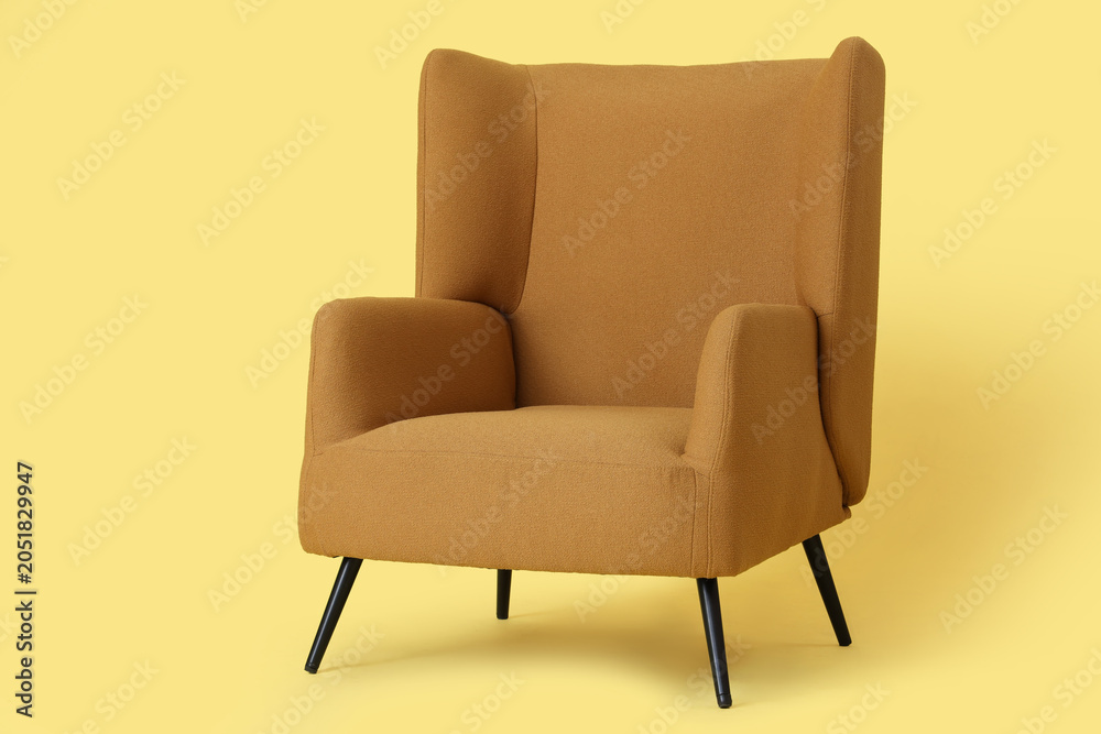 Fototapeta premium Cozy armchair on yellow background