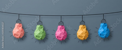 A String of Colorful Crumpled Paper Light Bulbs Representing Creative Ideas and Innovation on a Dark Gray Background