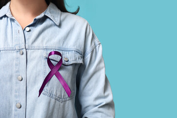 Woman with purple ribbon on blue background. Pancreatic cancer awareness concept