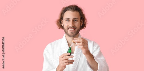 Smiling man in white robe a...