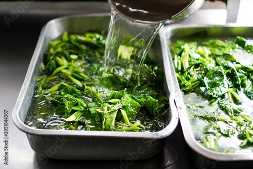 Photos Pouring Hot Water for Chinese Kale Blanching at Food Stall