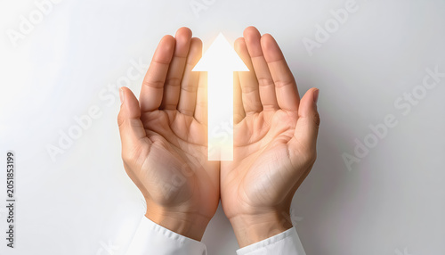 Top view of hands holding a bright upward arrow symbolizing financial growth