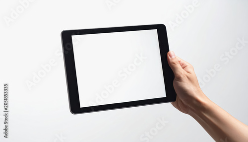 Hand holding tablet computer with blank white screen, ideal for app display or web design mockup