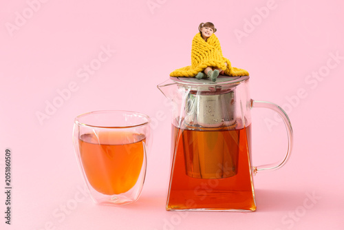 Teapot with hot tea and gla...
