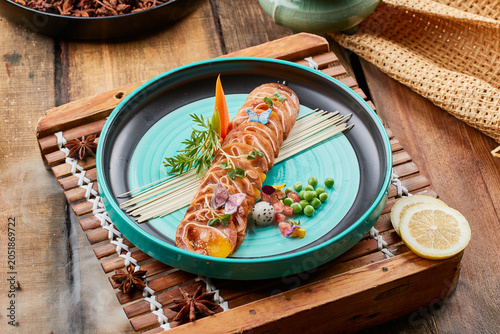 Slika na platnu Flavored braised pig ear flowers on a two-tone round porcelain plate on an old w