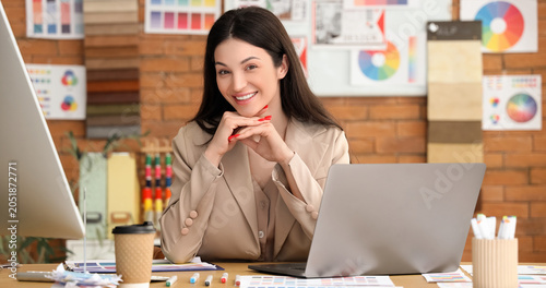 Photos Beautiful designer working at table in office