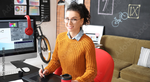 Young female designer worki...