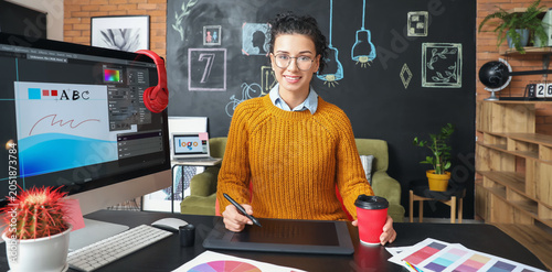Foto Young female designer working in office