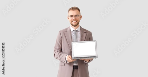 Smiling businessman holding...